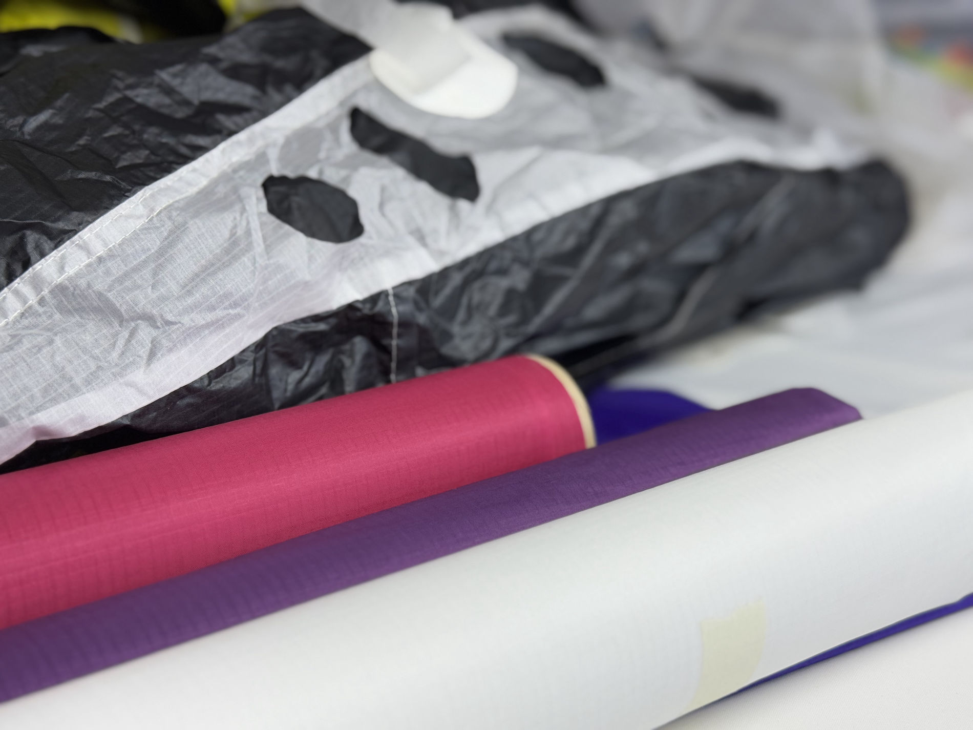 Purple, pink, white and black fabric materials.