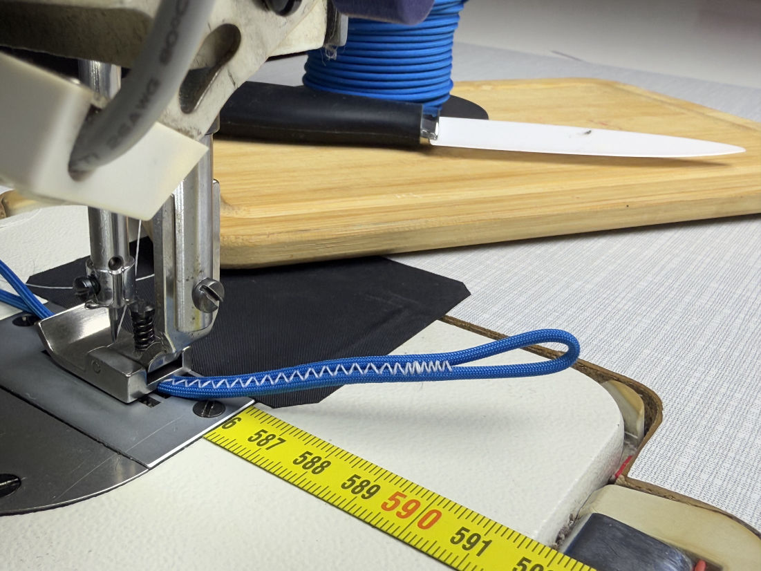 Machine sewing paraglider line.
