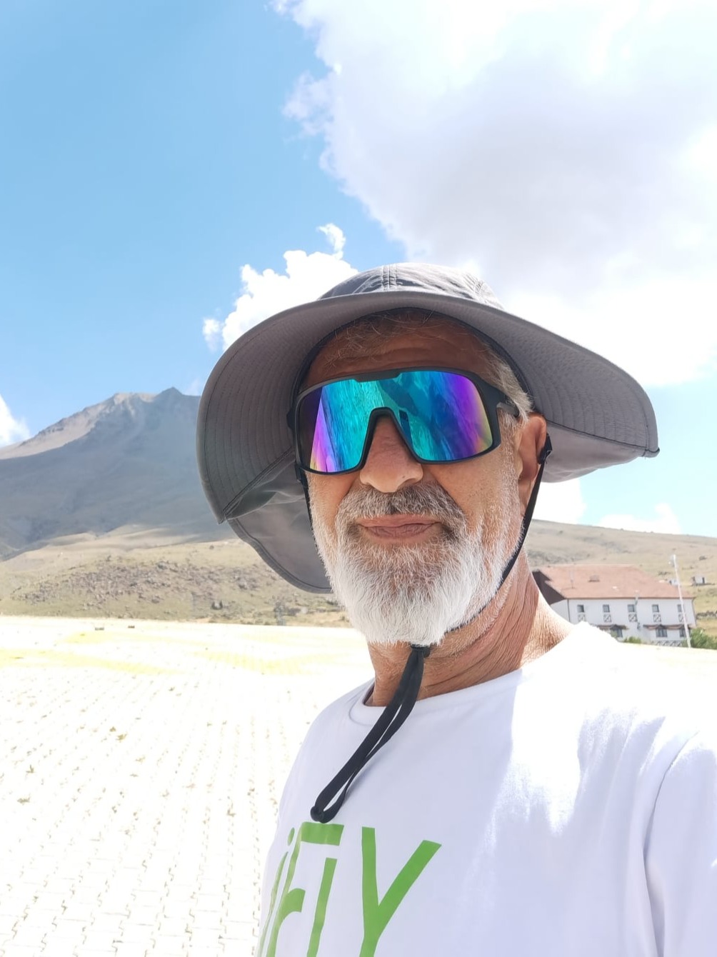 Fahri with sun glasses mountain in the background.